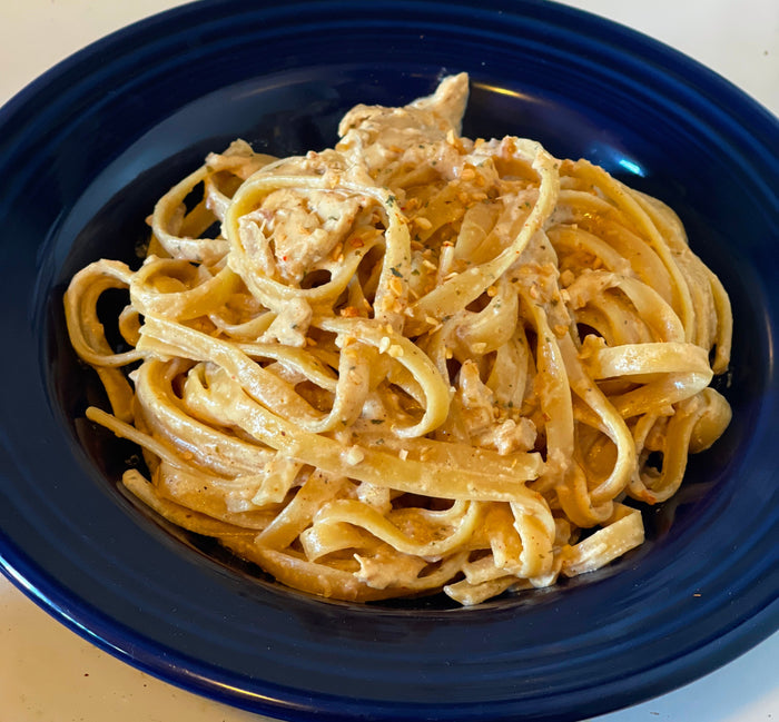 Bowl of fettucine alfredo made with Spicy Guac Seasoning From Lex's Pantry