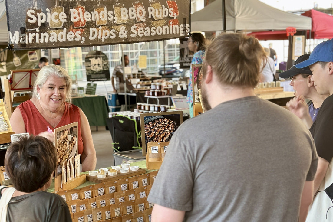 Alexa Clark and Gerry at From Lex’s Pantry farmers’ market table with handcrafted spice blends.
