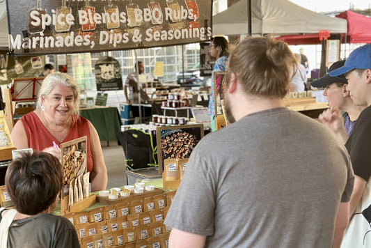 Alexa Clark and Gerry at From Lex’s Pantry farmers’ market table with handcrafted spice blends.