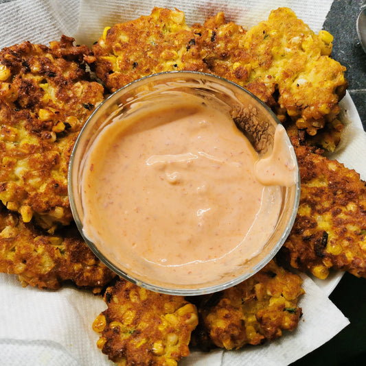 Shakshuka Market Sample Dip in a glass bowl with corn fritters on a layer of papertowels