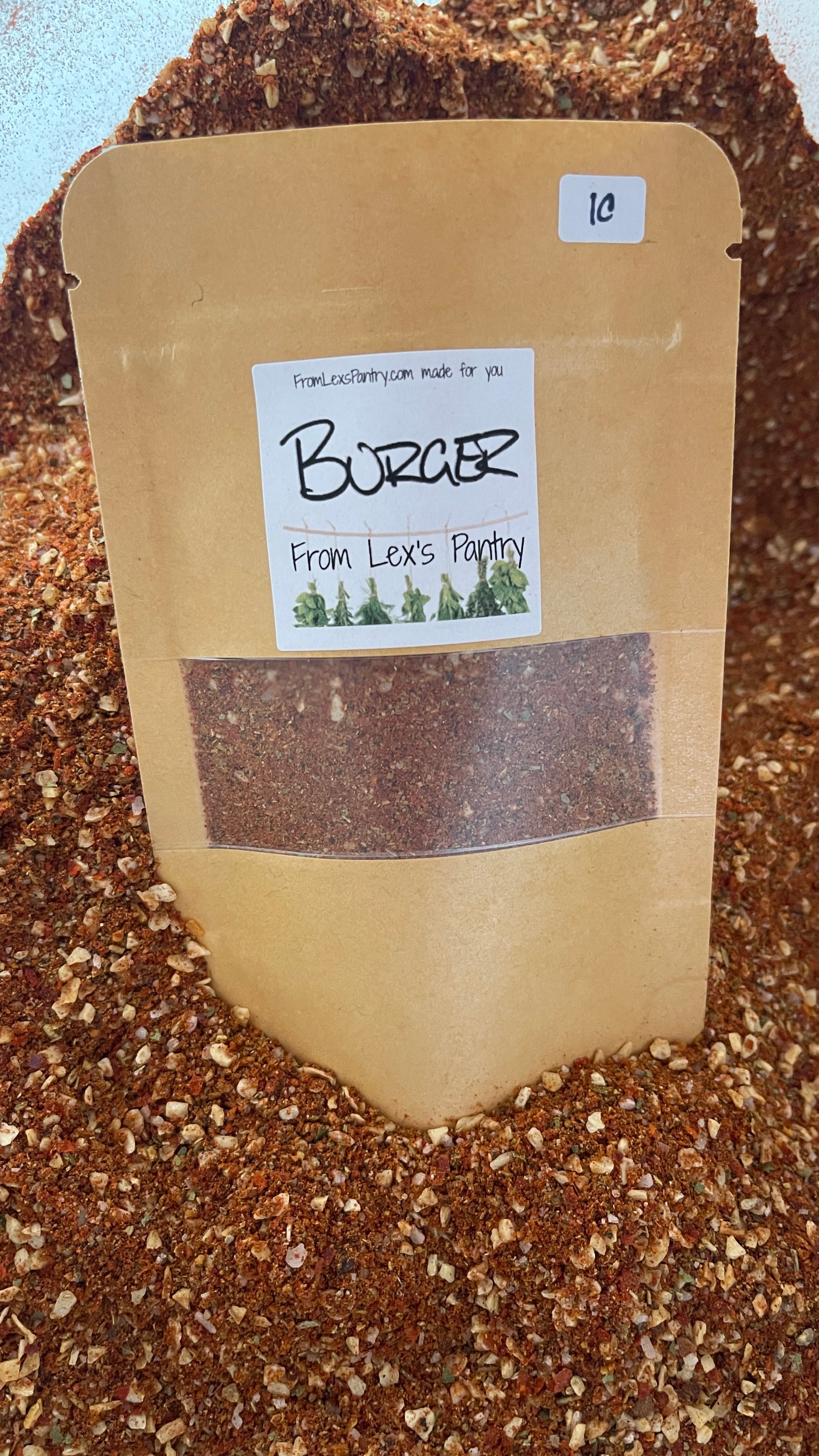 Package of Bay Burger Spice Blend sitting in a pile of the Bay Burger spice blend
